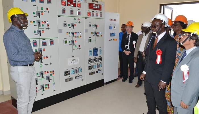 Kingsford Amoako (left), Technical Instructor of the centre, conducting dignitaries round the substation control panel. They include Mr Yonebayashi (right), Dr Marfo, Samuel Boakye-Appiah, Director, Network Projects, Isaac Manu-Marfo, General Manager, Maintenance, and Mrs Ama Engman, General Manager, Personnel.